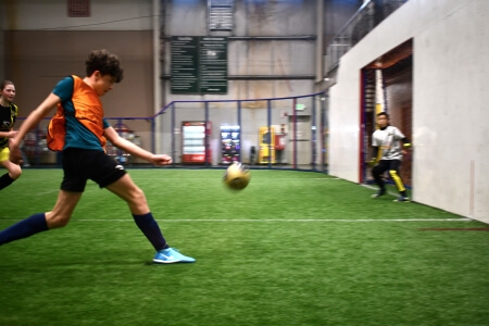 Kids playing indoor soccer